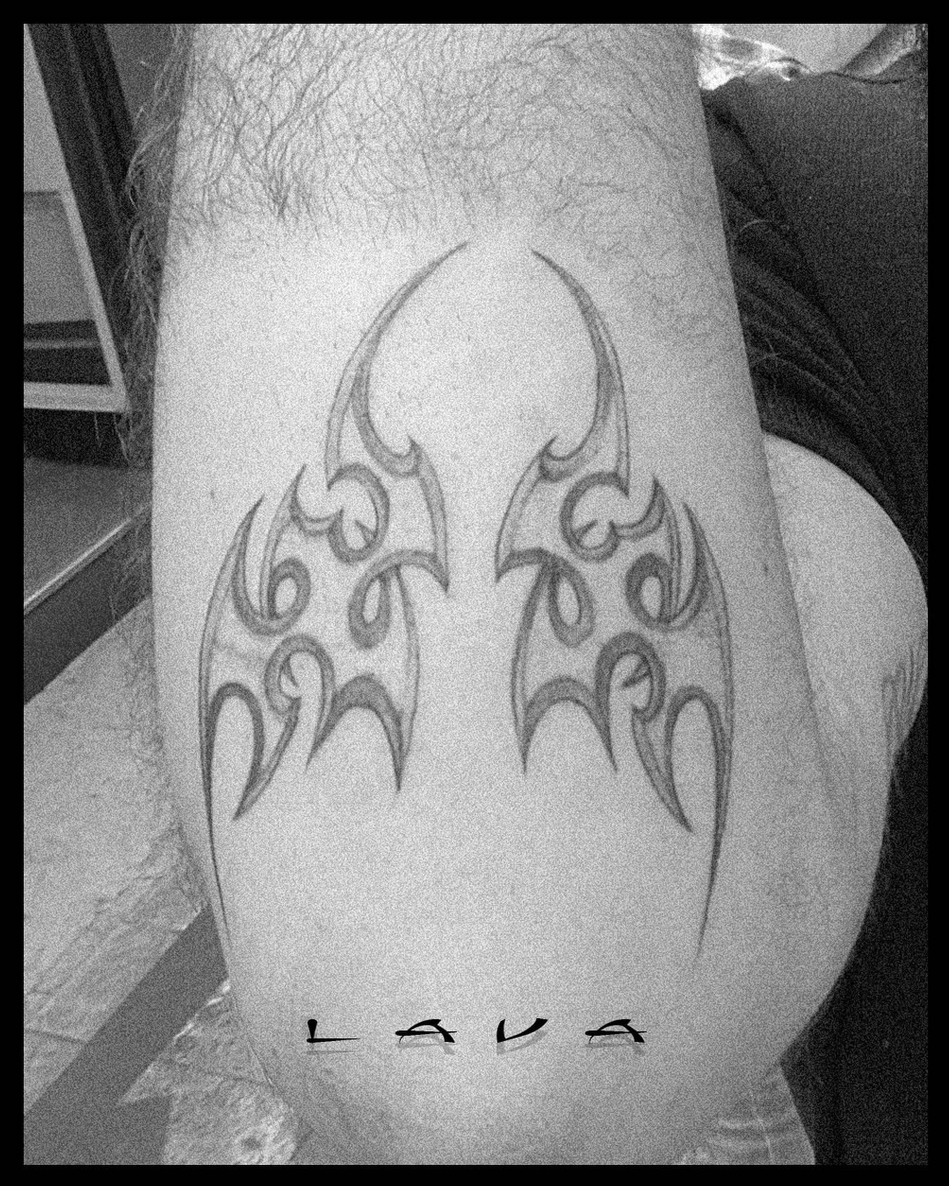 Modern symmetrical tribal tattoo on knee and calf, high-grain Y2K-aesthetic photograph, signed LAVA